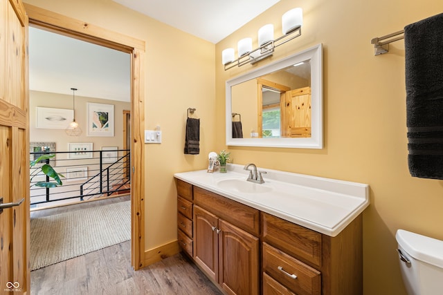 8426 N Chickadee Dr, Morgantown, IN 46160 - bathroom featuring vanity, wood finished floors, toilet, and baseboards