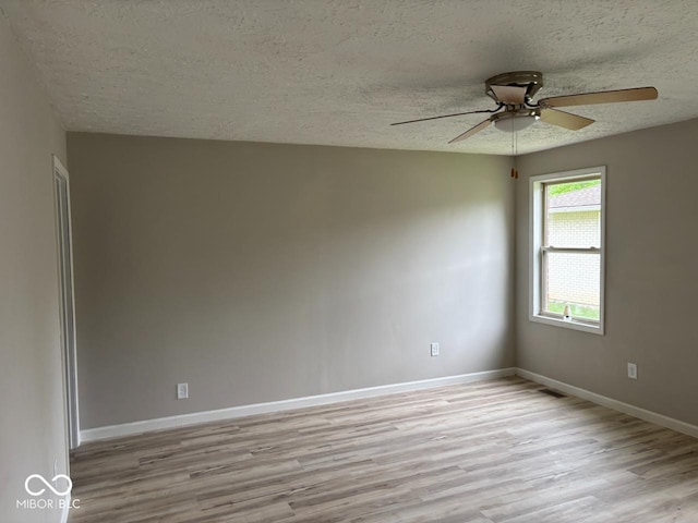 724 Iroquois St, Anderson, IN 46012 - spare room featuring a textured ceiling, light wood finished floors, ceiling fan, and baseboards
