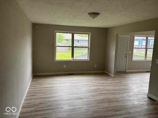 724 Iroquois St, Anderson, IN 46012 - unfurnished room with wood finished floors, a textured ceiling, and baseboards