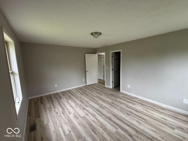 724 Iroquois St, Anderson, IN 46012 - unfurnished bedroom featuring light wood finished floors and baseboards