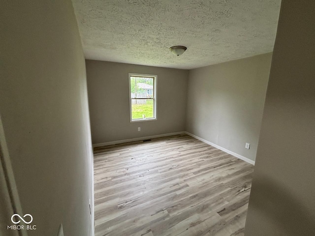 724 Iroquois St, Anderson, IN 46012 - unfurnished room featuring a textured ceiling, wood finished floors, and baseboards