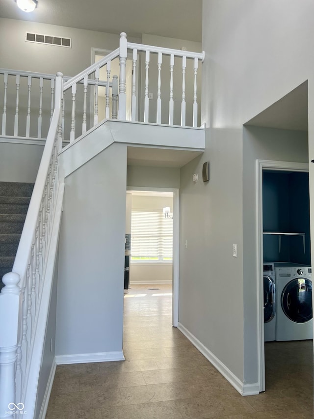 7532 Perilla Ct, Indianapolis, IN 46237 - staircase with washing machine and clothes dryer, baseboards, and a high ceiling