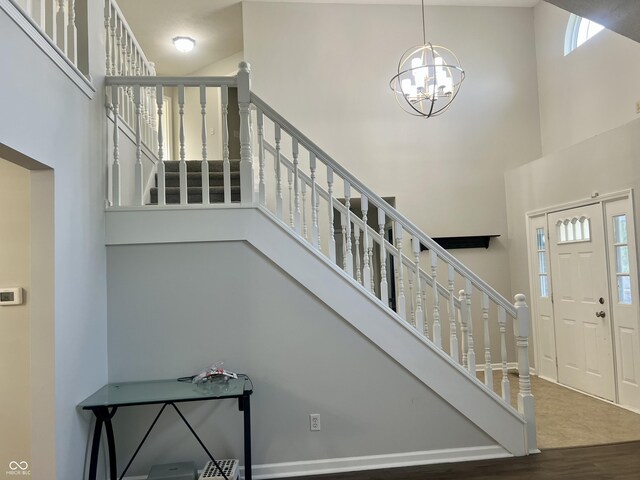 7532 Perilla Ct, Indianapolis, IN 46237 - entryway with a towering ceiling, stairs, wood finished floors, and a chandelier