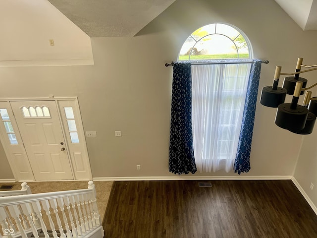 7532 Perilla Ct, Indianapolis, IN 46237 - foyer entrance with wood finished floors, vaulted ceiling, and baseboards