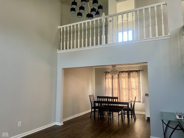 7532 Perilla Ct, Indianapolis, IN 46237 - dining area with a chandelier, a towering ceiling, baseboards, and wood finished floors