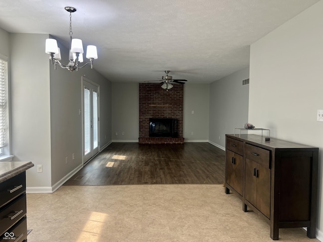 7532 Perilla Ct, Indianapolis, IN 46237 - unfurnished living room featuring ceiling fan, a chandelier, a brick fireplace, and baseboards