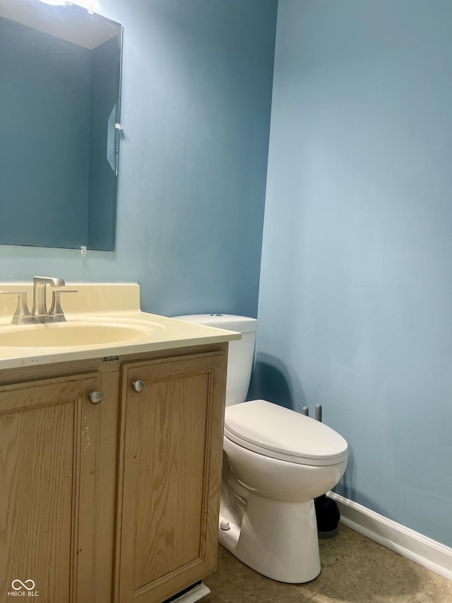 7532 Perilla Ct, Indianapolis, IN 46237 - half bathroom featuring toilet, vanity, and baseboards