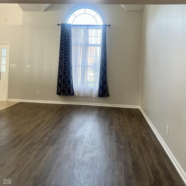 7532 Perilla Ct, Indianapolis, IN 46237 - spare room featuring dark wood-type flooring, healthy amount of natural light, and baseboards