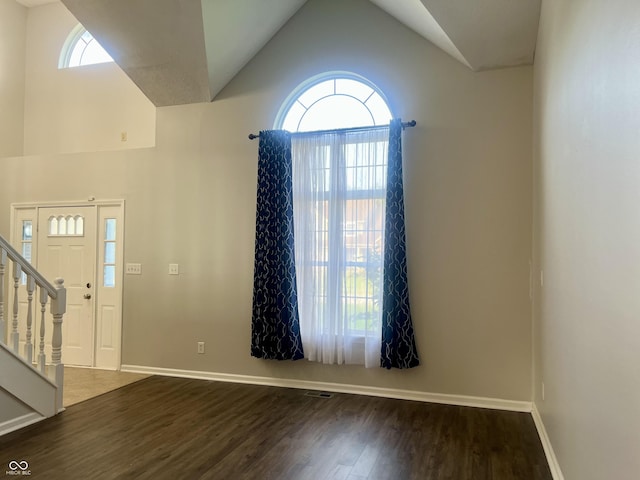 7532 Perilla Ct, Indianapolis, IN 46237 - foyer entrance featuring wood finished floors, baseboards, lofted ceiling, and stairs