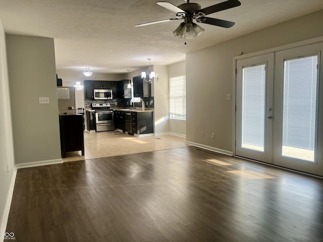 7532 Perilla Ct, Indianapolis, IN 46237 - unfurnished living room featuring a chandelier, baseboards, ceiling fan, french doors, and a sink