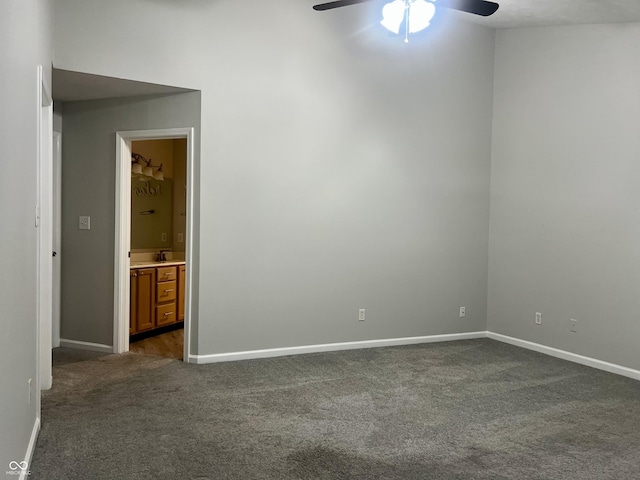 7532 Perilla Ct, Indianapolis, IN 46237 - spare room featuring dark colored carpet, a ceiling fan, baseboards, and a sink