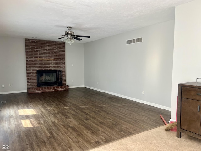 7532 Perilla Ct, Indianapolis, IN 46237 - unfurnished living room featuring ceiling fan, dark wood-style flooring, baseboards, and a brick fireplace