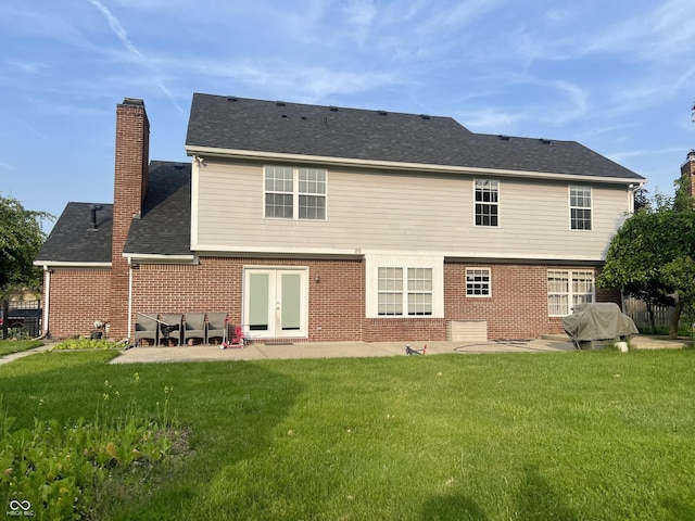 7532 Perilla Ct, Indianapolis, IN 46237 - back of property featuring a patio area, a chimney, brick siding, a yard, and french doors