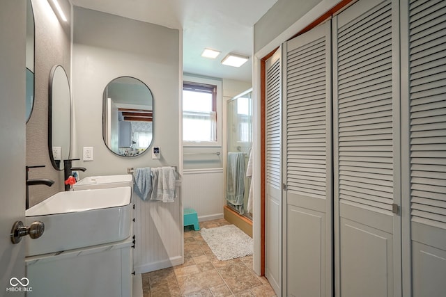 307 E 5th St, Sheridan, IN 46069 - bathroom with a closet, a stall shower, stone finish floors, and double vanity