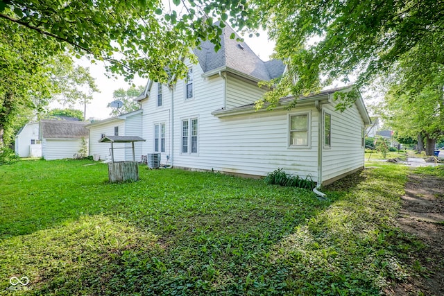 307 E 5th St, Sheridan, IN 46069 - back of house featuring central air condition unit, a lawn, and roof with shingles