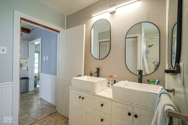 307 E 5th St, Sheridan, IN 46069 - bathroom with a wainscoted wall, double vanity, and stone finish flooring