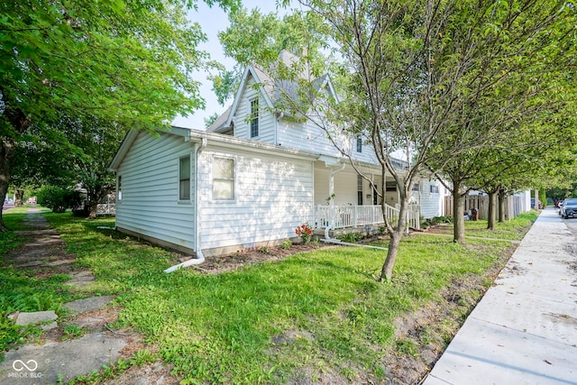 307 E 5th St, Sheridan, IN 46069 - view of home's exterior featuring a porch and a yard