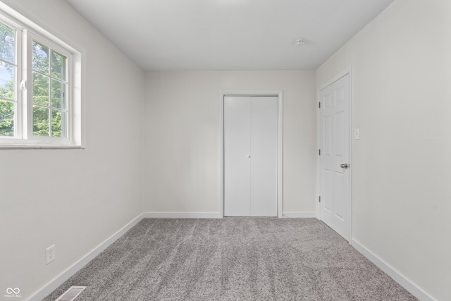 1948 Bloyd Ave, Indianapolis, IN 46218 - unfurnished bedroom featuring carpet flooring and a closet