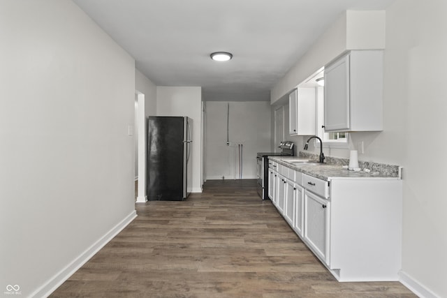 1948 Bloyd Ave, Indianapolis, IN 46218 - kitchen with stainless steel appliances, white cabinets, and wood finished floors