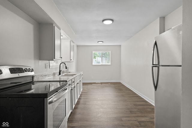 1948 Bloyd Ave, Indianapolis, IN 46218 - kitchen featuring stainless steel appliances, dark wood-type flooring, and white cabinetry