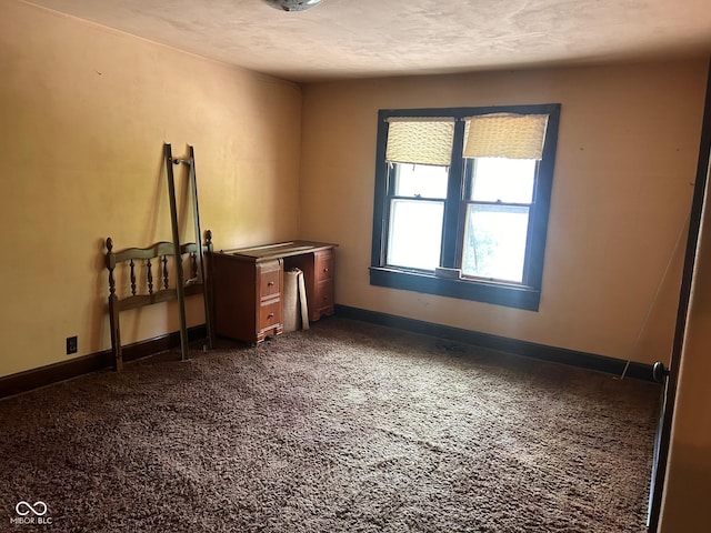 712 Cottage Ave, Anderson, IN 46012 - unfurnished bedroom featuring dark carpet and baseboards