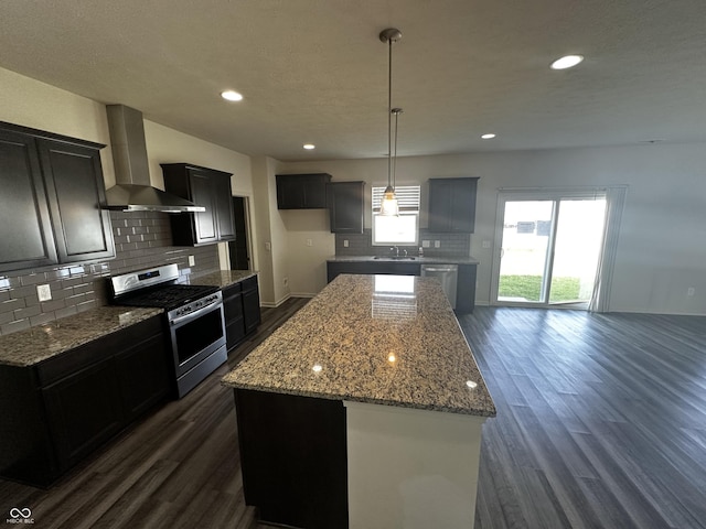 1218 Bedford Dr, Avon, IN 46123 - kitchen featuring stainless steel appliances, wall chimney range hood, dark wood-type flooring, backsplash, and recessed lighting