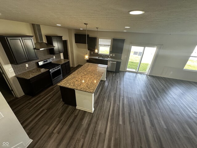 1218 Bedford Dr, Avon, IN 46123 - kitchen with stainless steel appliances, wall chimney exhaust hood, a textured ceiling, dark wood finished floors, and backsplash