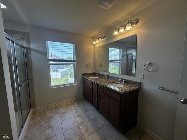 1218 Bedford Dr, Avon, IN 46123 - bathroom with healthy amount of natural light, double vanity, a shower stall, and baseboards