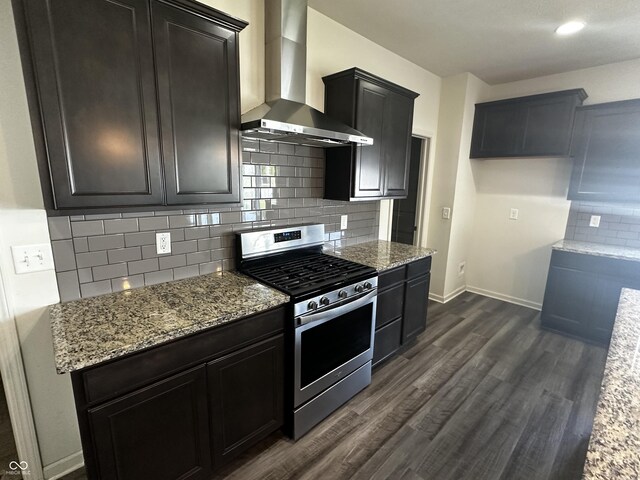 1218 Bedford Dr, Avon, IN 46123 - kitchen featuring stainless steel gas range, wall chimney range hood, light stone countertops, dark wood-style flooring, and backsplash