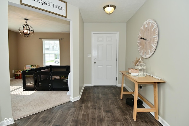 680 Albermarle Dr, Pittsboro, IN 46167 - entrance foyer with dark wood-type flooring, baseboards, and a chandelier