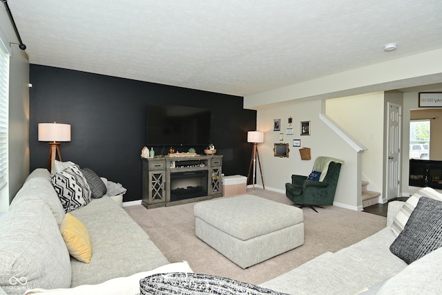 680 Albermarle Dr, Pittsboro, IN 46167 - carpeted living room with stairs, baseboards, an accent wall, and a textured ceiling