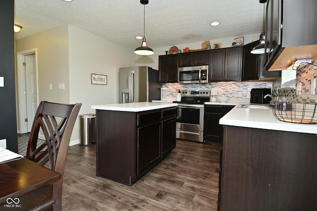 680 Albermarle Dr, Pittsboro, IN 46167 - kitchen featuring stainless steel appliances, tasteful backsplash, dark wood-type flooring, light countertops, and a kitchen island