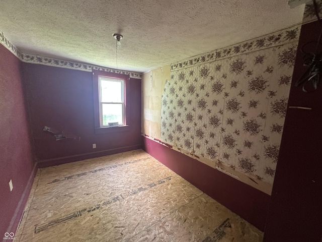 1739 E 18th St, Anderson, IN 46016 - unfurnished room with a textured ceiling and baseboards