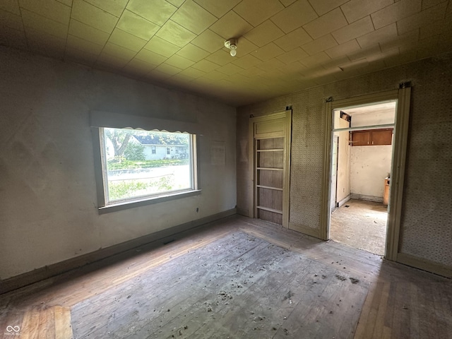 1739 E 18th St, Anderson, IN 46016 - unfurnished bedroom featuring hardwood / wood-style floors and baseboards