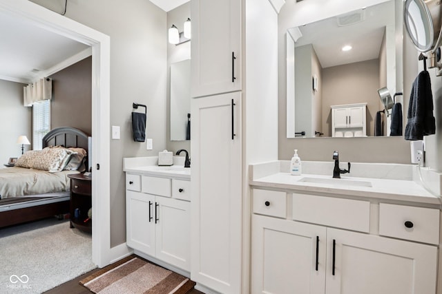 1295 Maclaren Ct, Franklin, IN 46131 - ensuite bathroom featuring two vanities, baseboards, ornamental molding, and wood finished floors