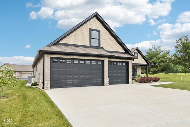 1295 Maclaren Ct, Franklin, IN 46131 - view of side of property with a garage, a yard, central air condition unit, stone siding, and concrete driveway