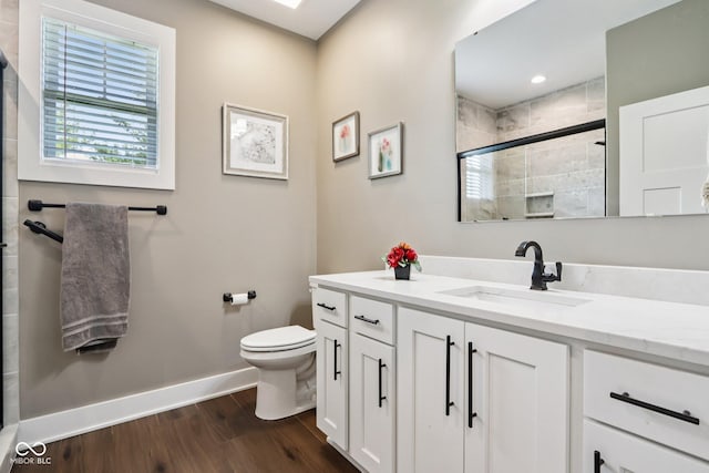 1295 Maclaren Ct, Franklin, IN 46131 - full bathroom featuring baseboards, wood finished floors, toilet, vanity, and tiled shower