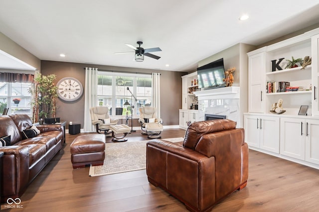 1295 Maclaren Ct, Franklin, IN 46131 - living room with wood finished floors, a ceiling fan, a tile fireplace, and recessed lighting