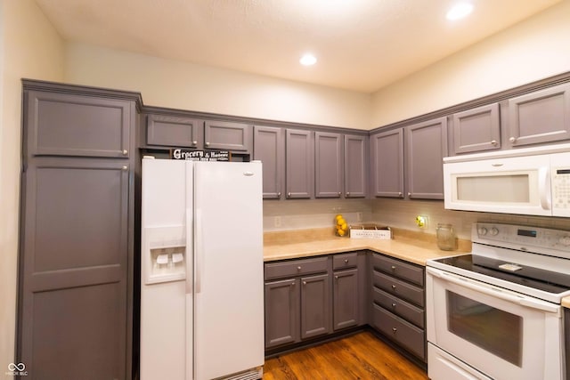 4291 Washington Blvd, Plainfield, IN 46168 - kitchen featuring white appliances, gray cabinets, light countertops, dark wood-style flooring, and recessed lighting