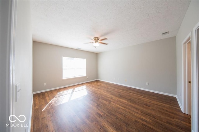 4291 Washington Blvd, Plainfield, IN 46168 - spare room with a textured ceiling, a ceiling fan, baseboards, and dark wood-style flooring