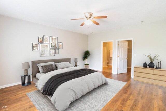 4291 Washington Blvd, Plainfield, IN 46168 - bedroom featuring wood finished floors, baseboards, a ceiling fan, and ensuite bath