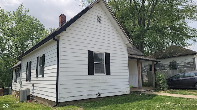 7879 Main St, Coatesville, IN 46121 - view of side of property featuring central AC unit and a chimney