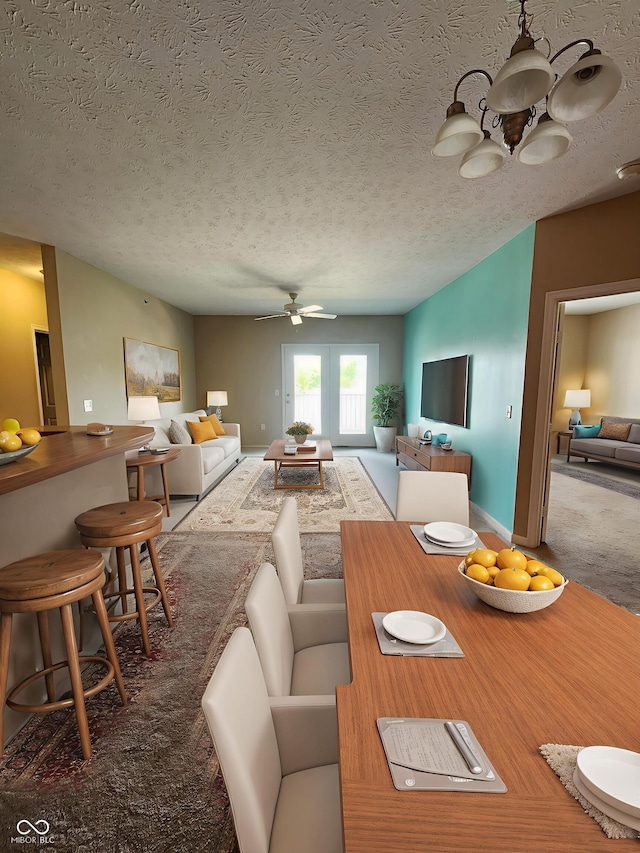 5011 Amber Creek Pl Unit 205, Indianapolis, IN 46237 - carpeted dining room with a chandelier, ceiling fan, and a textured ceiling