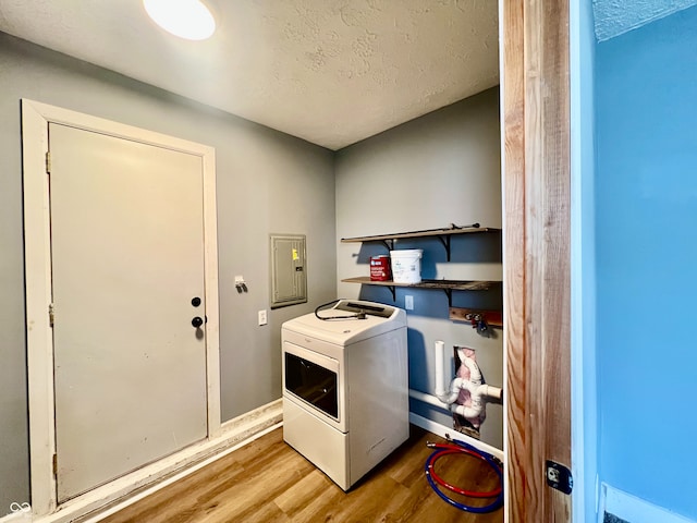 2833 Desoto Way, Columbus, IN 47203 - washroom with washer / clothes dryer, electric panel, wood finished floors, a textured ceiling, and baseboards