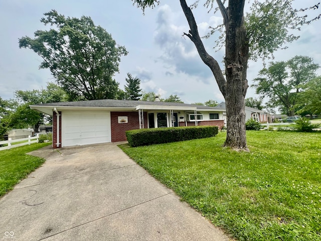 2833 Desoto Way, Columbus, IN 47203 - ranch-style house featuring brick siding, an attached garage, and concrete driveway