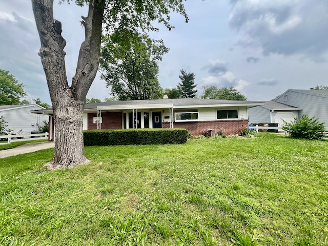 2833 Desoto Way, Columbus, IN 47203 - ranch-style house featuring brick siding, a front lawn, and driveway