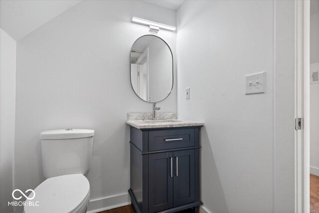 1709 Fletcher Ave, Indianapolis, IN 46203 - bathroom with vanity, baseboards, and toilet