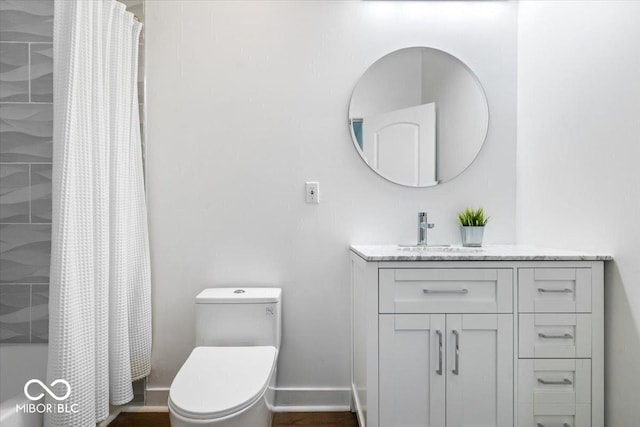 1709 Fletcher Ave, Indianapolis, IN 46203 - bathroom featuring vanity, toilet, shower / tub combo with curtain, and baseboards