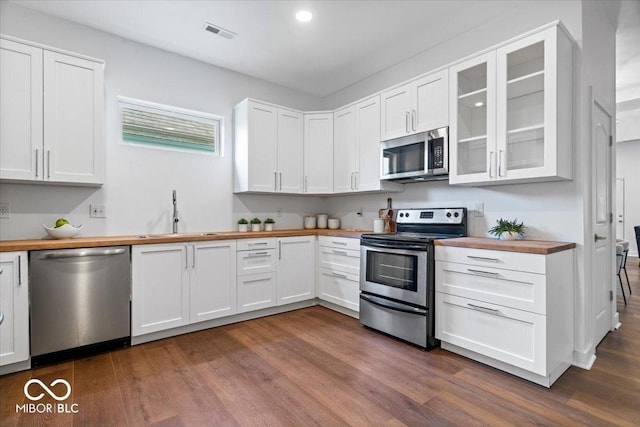 1709 Fletcher Ave, Indianapolis, IN 46203 - kitchen featuring appliances with stainless steel finishes, wooden counters, a sink, dark wood finished floors, and recessed lighting