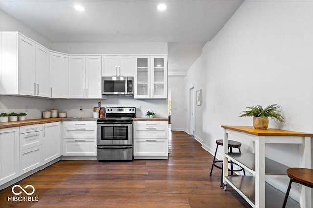 1709 Fletcher Ave, Indianapolis, IN 46203 - kitchen featuring stainless steel appliances, white cabinets, glass insert cabinets, dark wood-type flooring, and recessed lighting
